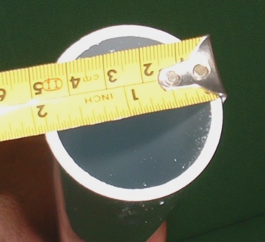 Measuring a pool pipe with a tape measure